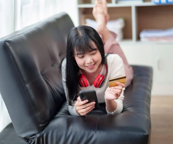 Asian businesswoman enjoying online shopping is paying by credit card. Pay by credit card via mobile